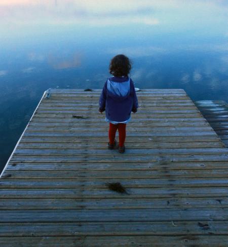 Child looking out on the pier
