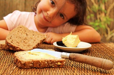 Child preparing to eat bread and butter