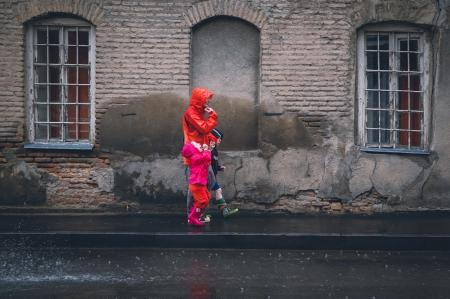 Children and Man Walking on a Sidewalk during Daytime