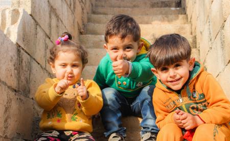 Children Sitting On The Stairs Doing Pose