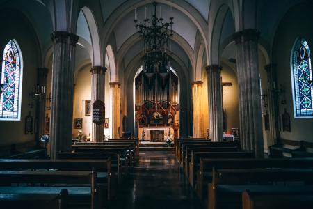 Church Pews Near Concrete Pillars in Church