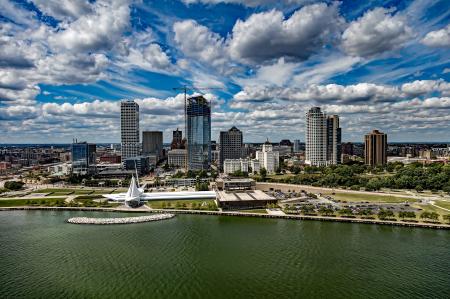 City at Waterfront Against Cloudy Sky