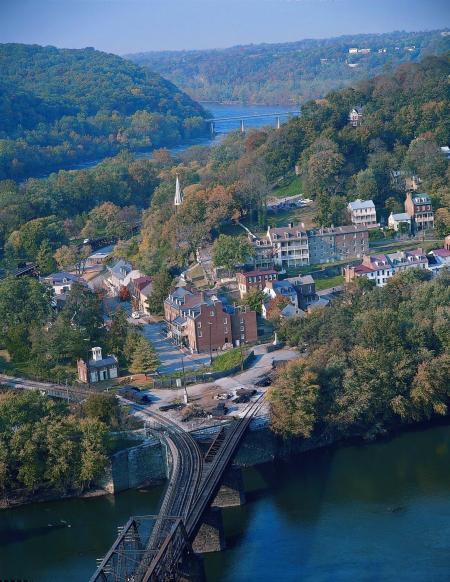 City Buildings Near Body of Water and Mountain