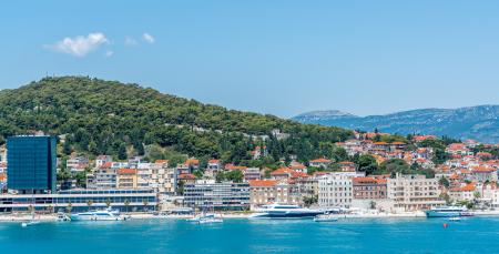 City Buildings Near Body of Water and Mountain