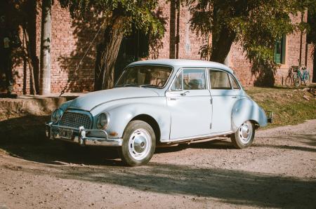 Classic Blue Sedan Near Green Leaf Trees at Daytime