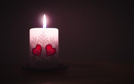 Close-up of Illuminated Candle Against Black Background