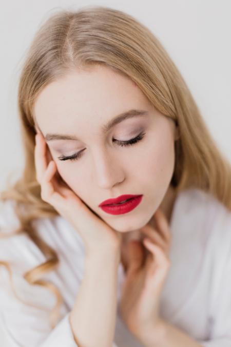 Close Up Photo of a Woman With Blonde Hair Wearing White Bathrobe