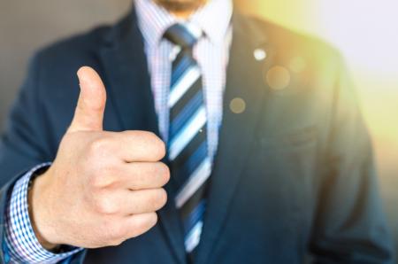 Close-up Photo of Man Wearing Black Suit Jacket Doing Thumbs Up Gesture