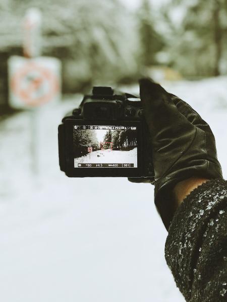 Close-up Photo of Person Holding Black Camera