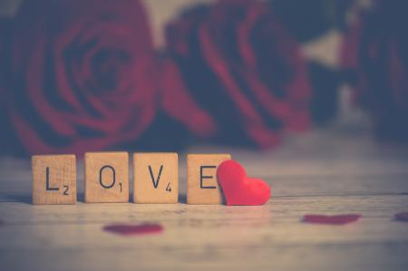 Close-up Photo of Wooden Scrabble Tiles Near Heart