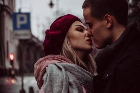 Close Up Photograph of Woman Kissing Man