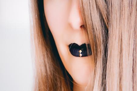 Close-up Photograph of Woman Wearing Black Lipstick