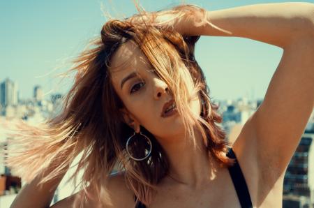 Close-up Photography of a Woman Touching Her Hair