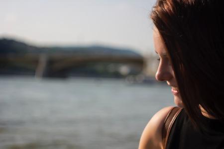 Close Up Photography of Side View Angle of a Woman Smiling Near Seawater during Daytime