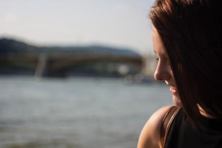 Close Up Photography of Side View Angle of a Woman Smiling Near Seawater during Daytime