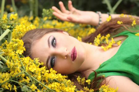 Close-up Portrait of Young Woman With Yellow Flowers