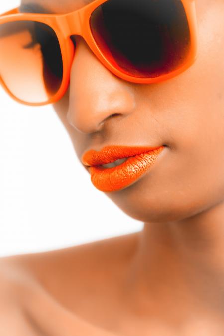 Closeup and Selective Focus Photograph of Woman Wearing Orange-framed Wayfarer-style Sunglasses