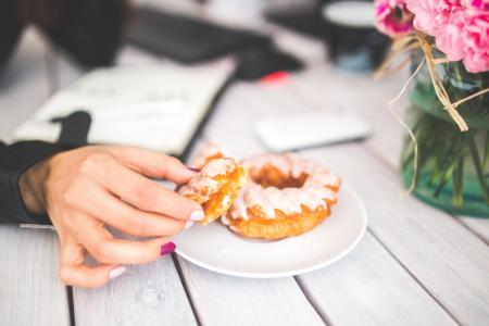 Closeup photo of hand choosing donut