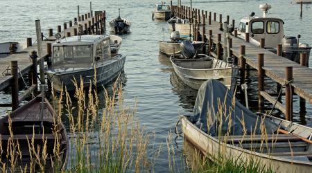 Cluster of Grey Motorboat on Brown Wooden Dock