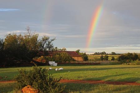 Colourful rainbow behind the village