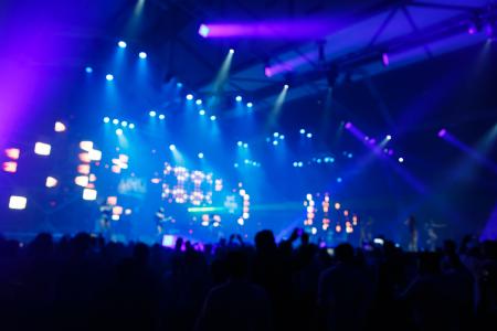Concert crowd in front of bright stage