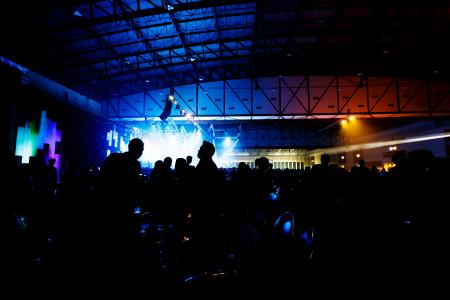 Concert crowd in front of bright stage
