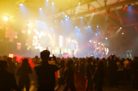 Concert crowd in front of bright stage