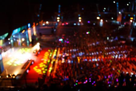 Concert crowd in front of bright stage