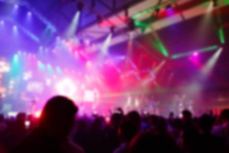 Concert crowd in front of bright stage