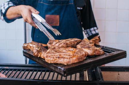 Cooked Meat On Black Metal Grill