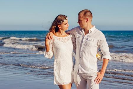 Couple Looking at Each Other Beside Beach