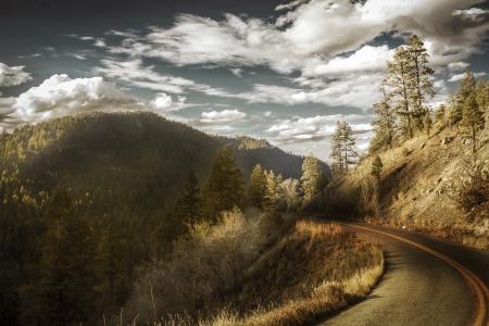 Curved Asphalt Road Between Mountains