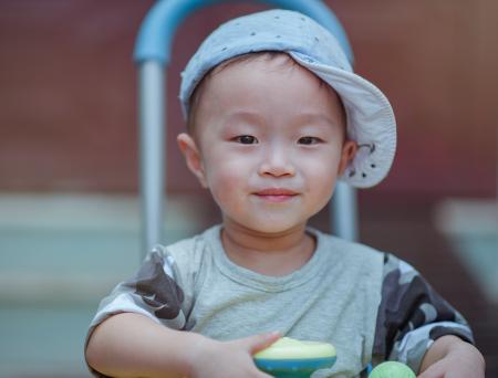 Depth of Field Photo of Boy Wearing Blue Cap