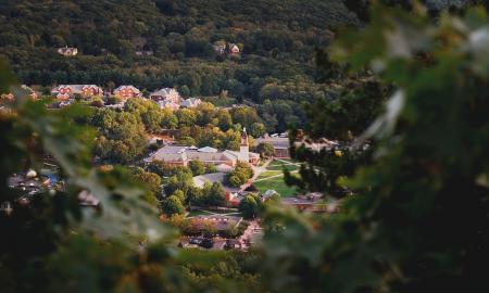 Depth of Field Photography of Church Surrounded of Tall Trees