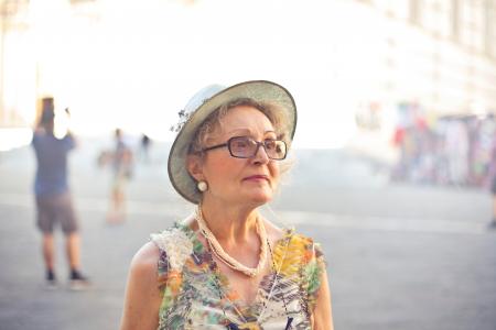 Depth of Field Photography of Woman in Pastel Color Sleeveless Shirt and White Sunhat