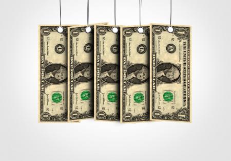 Dollar bills as labels hanging from a thread