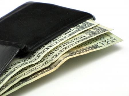 Dollar bills in a black wallet