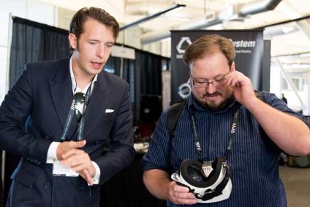 Ed Mason (CEO GameFace Labs) with Reverend Kyle holding GameFace HMD at SVVR expo