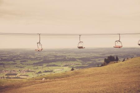 Empty Ski Lift Passing by Mountain during Daytime