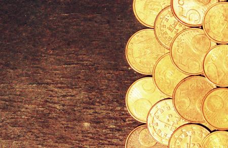 Euro coins on old wooden background