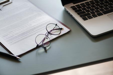 Eyeglasses With Black Frame Beside Macbook Pro