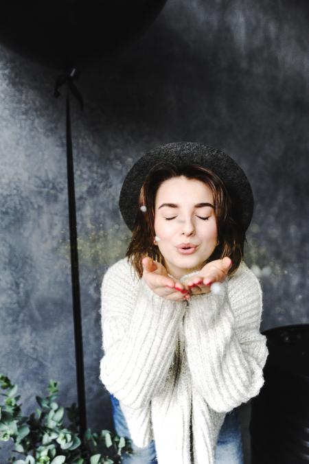 Female Wearing Hat Blowing Kisses