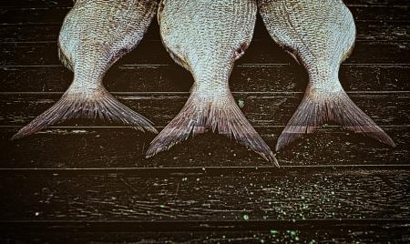 Fish ready to smoke on wood background