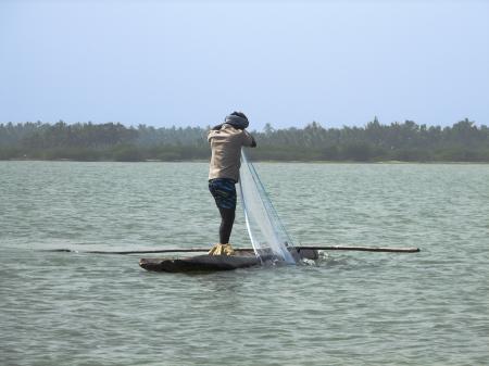 Fisherman in a log boat