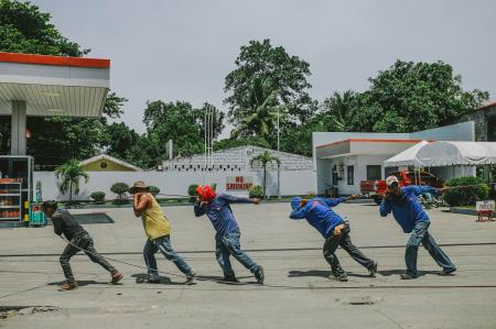 Five Men Pulling Black Rope