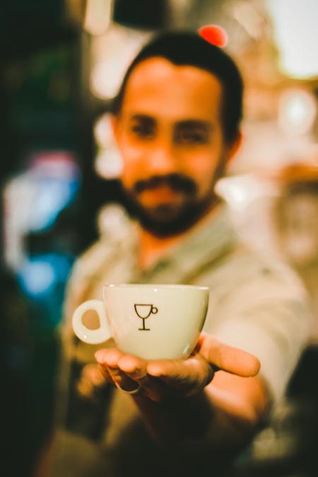 Focus Photography of Man Holding Ceramic Teacup