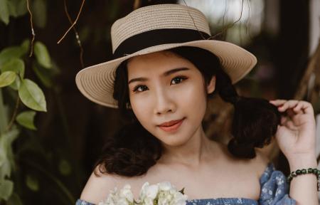 Focus Photography of Woman in Brown Sunhat Near Vine Plant