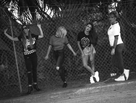 Four Women Leaning on Grid Fence