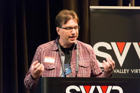 Frank Nora (developer of Nightstation, representing New York City VR Meet-Up) giving 60 Second Pitch at SVVR (eyes closed and closing both hands)