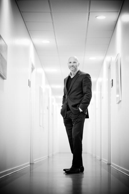 Full Length Portrait of Man Standing in Corridor